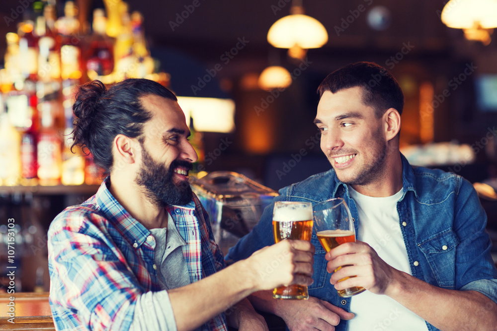 happy male friends drinking beer at bar or pub