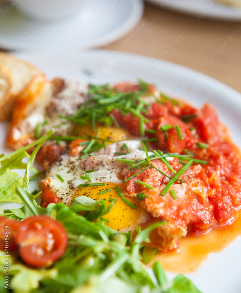 shakshuka fried eggs with sauce macro. horizontal background shakshuka fried eggs with sauce macro. horizontal background