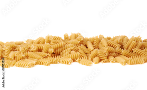 Line made of dry rotini pasta over isolated white background
