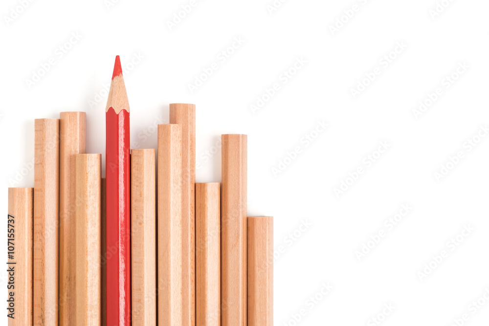 Isolated red colored pencil stand out of other brown pencils Isolated red colored pencil stand out of other brown pencils