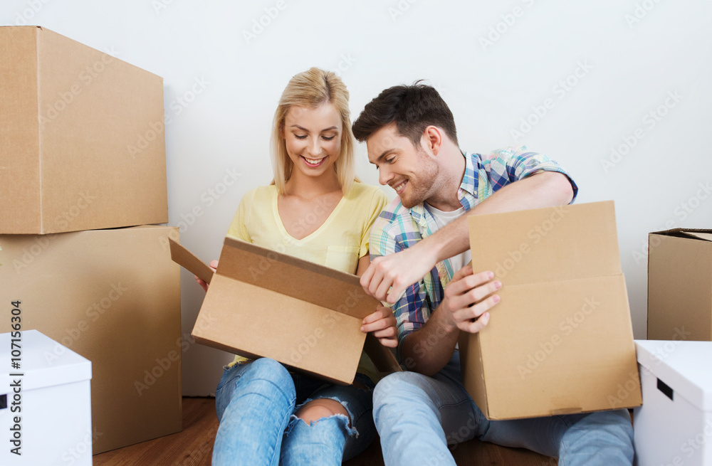 smiling couple with many boxes moving to new home smiling couple with many boxes moving to new home
