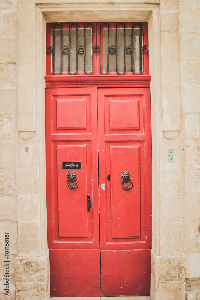 Red Wooden Doors with Black Lion Shaped Knockers in Mdina, Malta Red Wooden Doors with Black Lion Shaped Knockers in Mdina, Malta