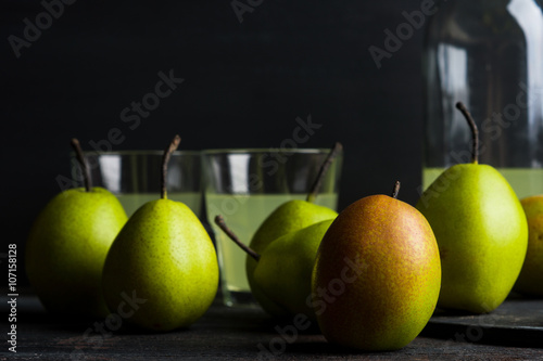 Fresh pears on a rustic wooden background