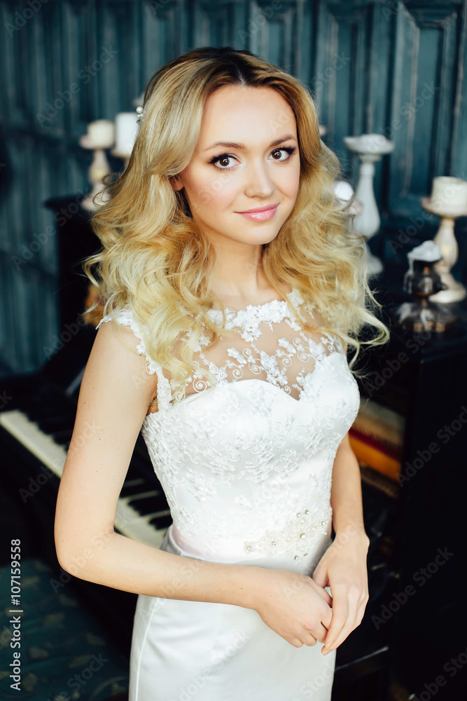 Fototapeta premium Portrait of beautiful young bride with curly hair
