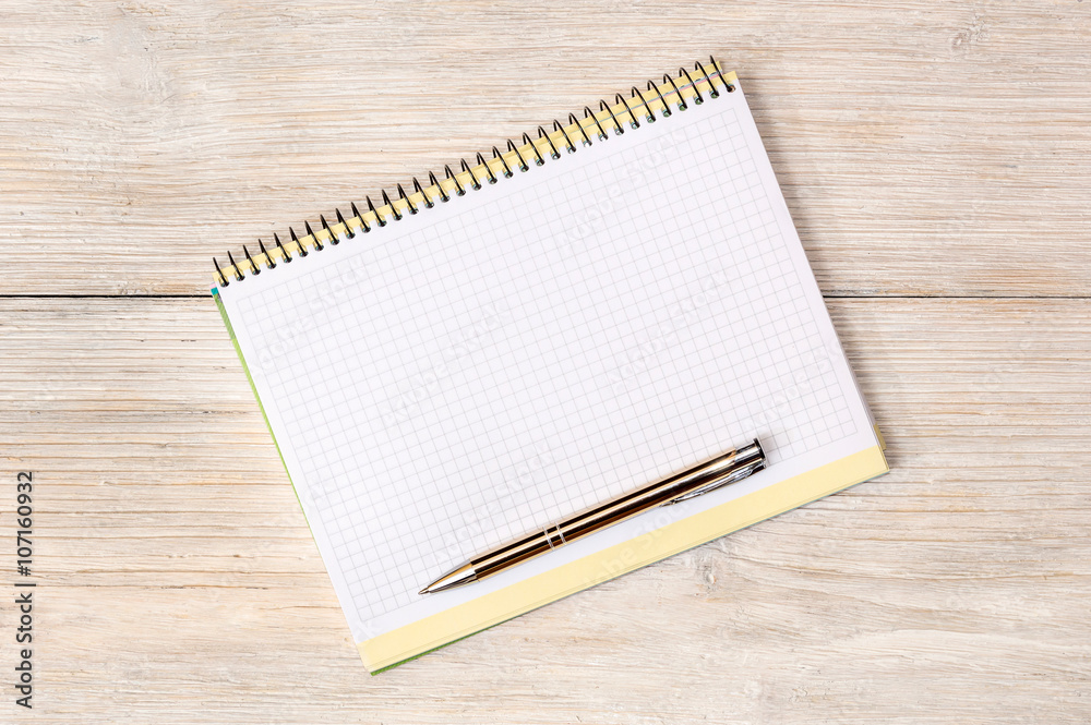 Notepad with pen on white wooden background Notepad with pen on white wooden background