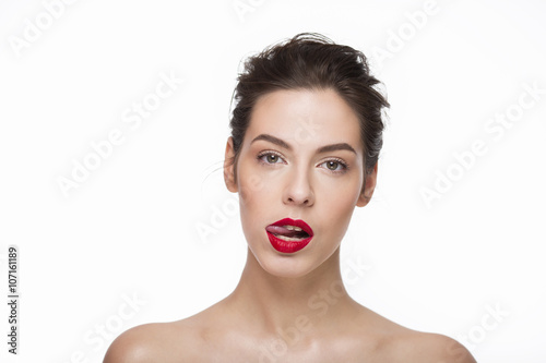 Image of a beautiful girl with red lipstick lick her lips over white background. Isolated
