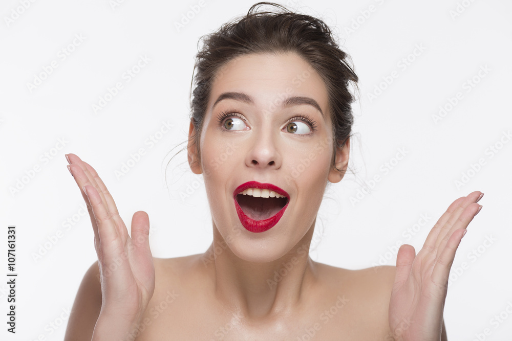 confused girl with red lipstick over white background. confused girl with red lipstick over white background.
