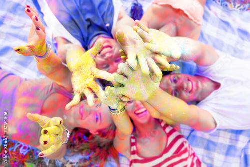 lying group of young adult pushes his hands up