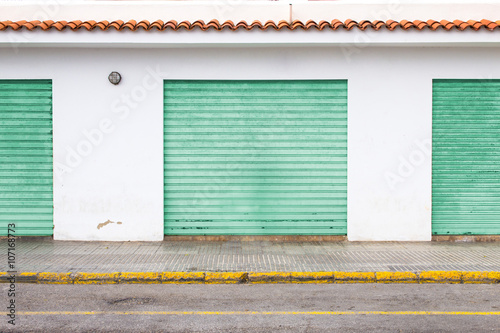 Canvas-taulu Industrial retro wall with coloured garages in spanish style
