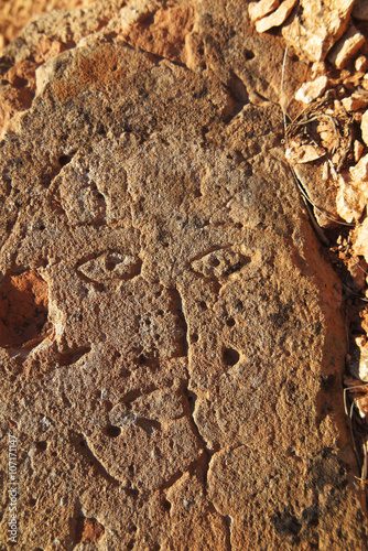 Prehistoric engraved stone face imitation