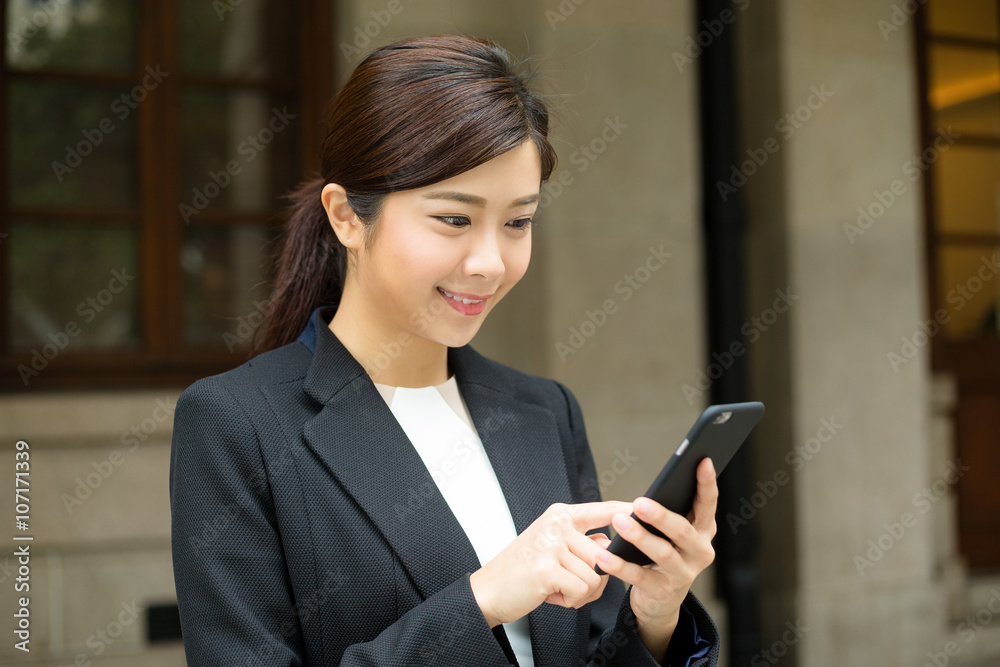 Businesswoman use of mobile phone at outdoor Businesswoman use of mobile phone at outdoor