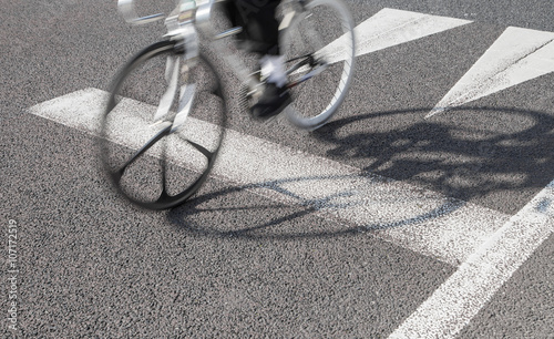 Bicycle moving on cleaned asphalt road in sunny day
