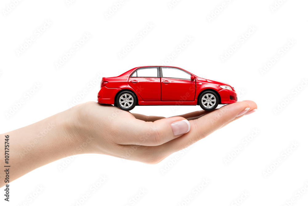 Toy car on female hand on white background.