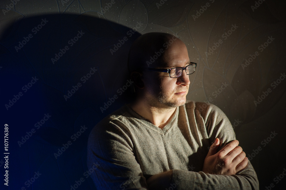 man with glasses sitting in the dark room stay home quarantined man with glasses sitting in the dark room stay home quarantined
