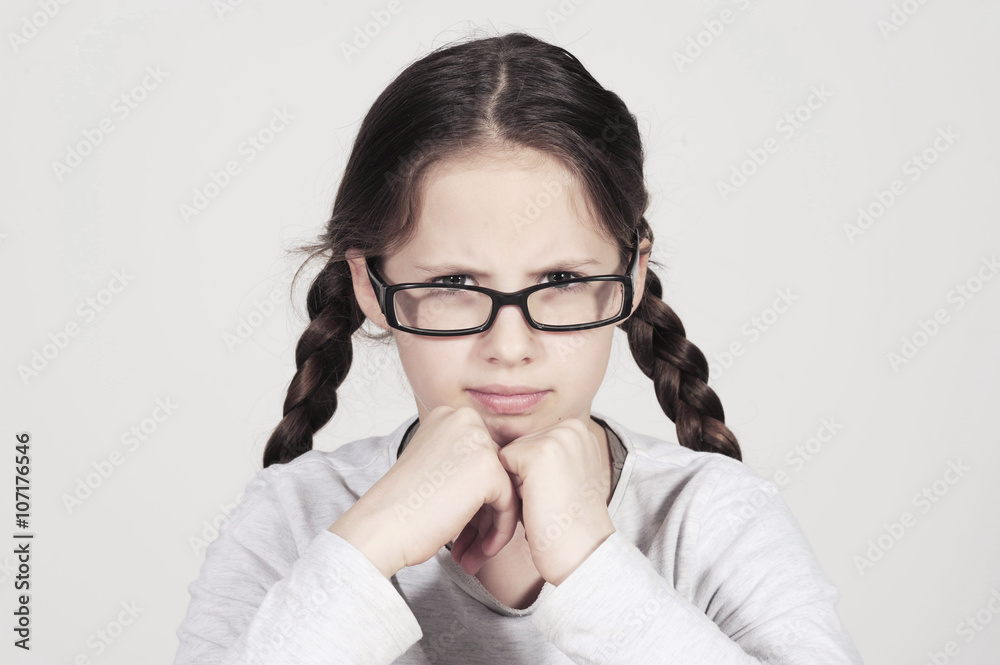 funny teenager girl looks angry behind her spectacles funny teenager girl looks angry behind her spectacles