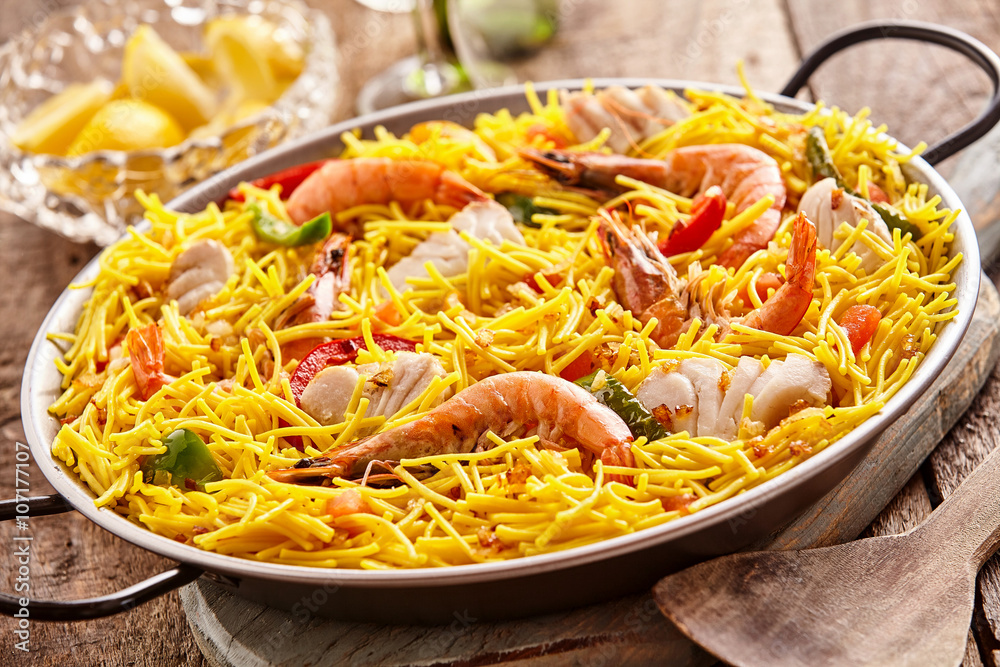 Yellow noodles and seafood recipe in pan