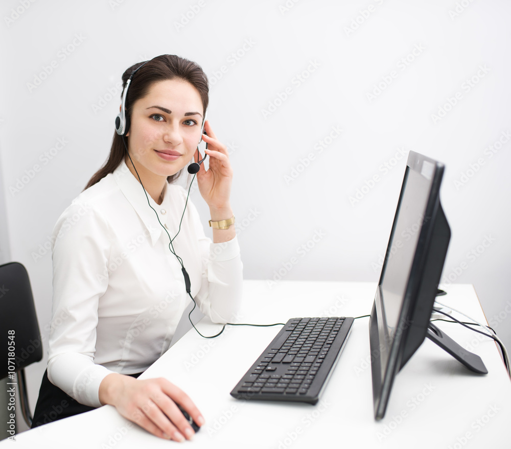 beautiful business woman working at a computer with headphones beautiful business woman working at a computer with headphones