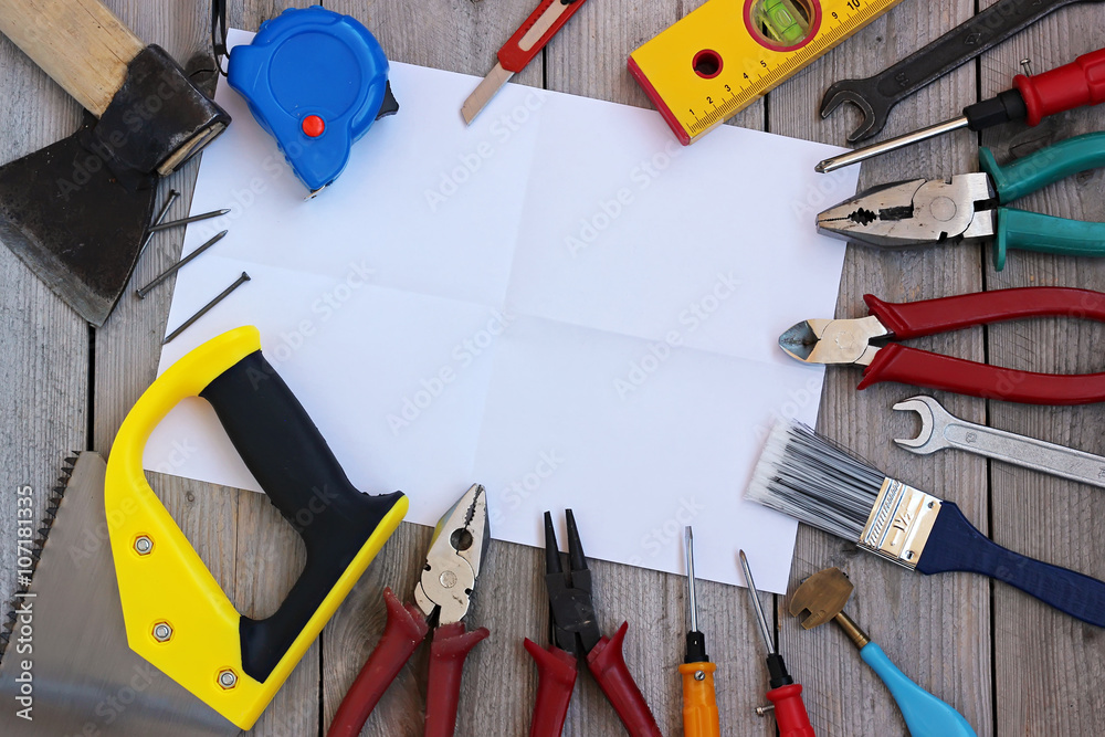 Carpentry tools on wooden floor, view from above.