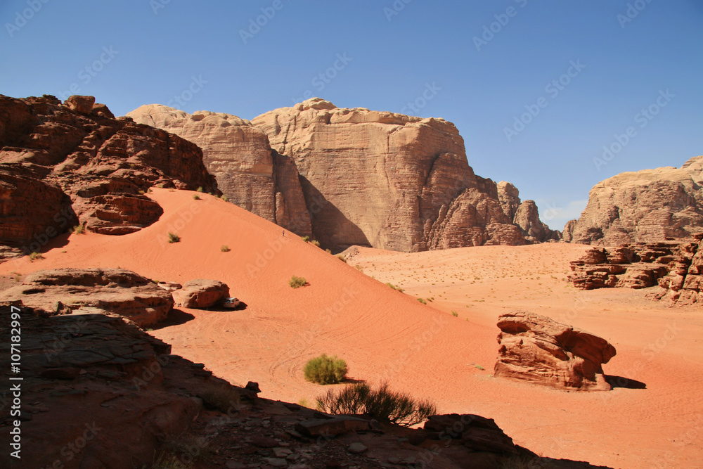 Jordanian Desert Mountain in Wadi Rum, Jordan at twilight. Wadi Rum is known as The Valley of the Moon and a UNESCO World Heritage Site. Jordanian Desert Mountain in Wadi Rum, Jordan at twilight. Wadi Rum is known as The Valley of the Moon and a UNESCO World Heritage Site.
