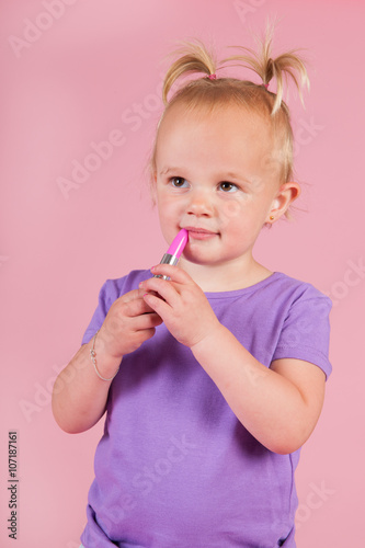 Toddler girl in pink with lipstick