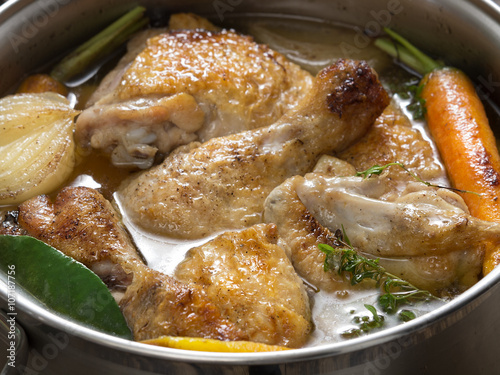 Traditional French cuisine - chicken in wine, coq au vin photo