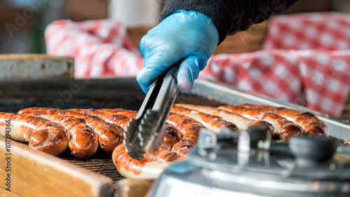 Sausages Cooking On Grill. Street Food Market Vendor photo