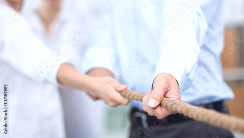 Concept image of business team using a rope as an element  the teamwork on foreground