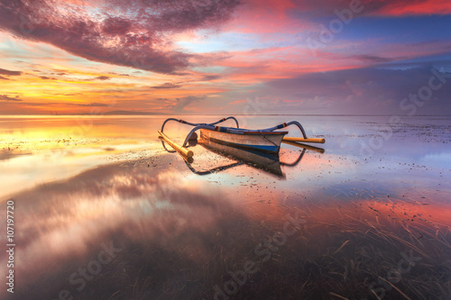 Beautiful Sunrise Scene in Bali, Indonesia. The boat ( Jukung) at Sanur Beach