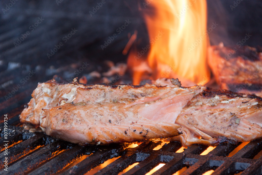 Fresh mouth watering wild caught salmon being grilled over charcoal and ...