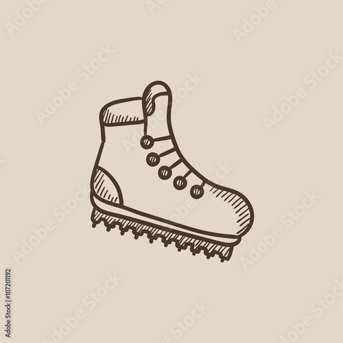 Hiking boot with crampons sketch icon.