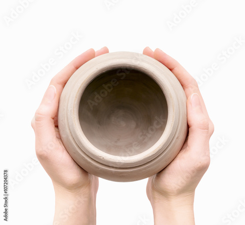 Unburnt clay pot in a woman's hands photo