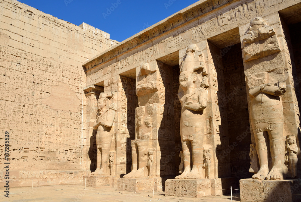 Colossal statues at Mortuary Temple of Ramses III in Luxor,Egypt Stock ...