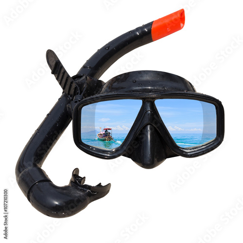 The ship tail-long at ocean landscape is reflected in diving mask and snorkel on the beach.