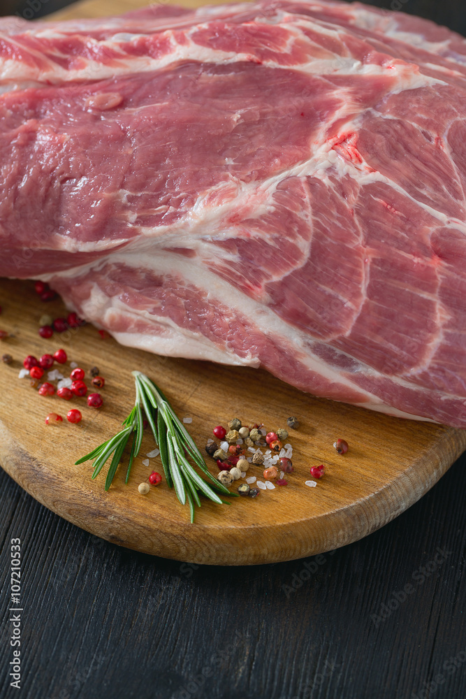 raw pork neck meat on wooden table