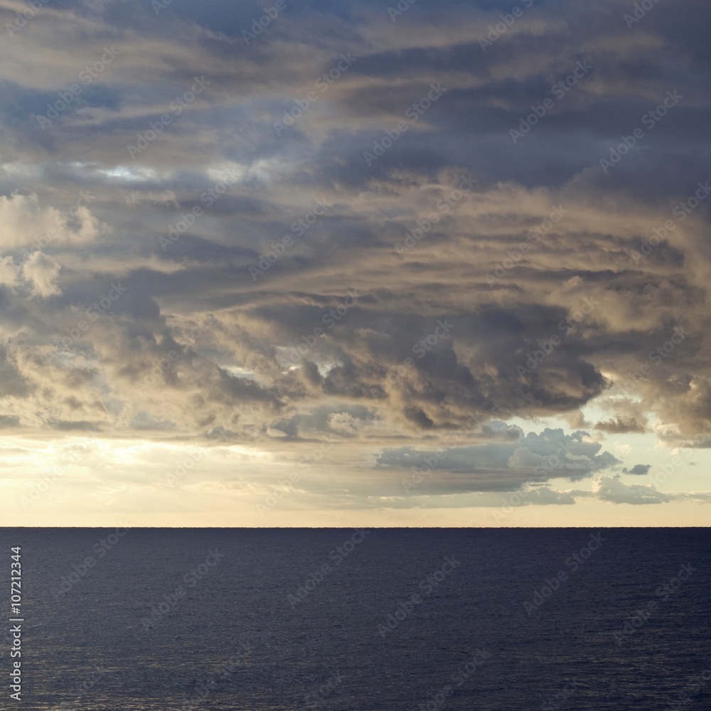 Dark cumulus clouds hovering over the sea