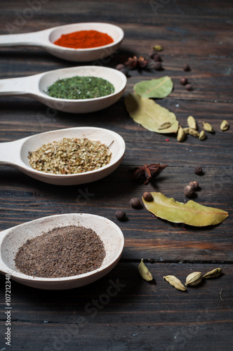 Spice in Wooden spoon on a wooden background. Pepper