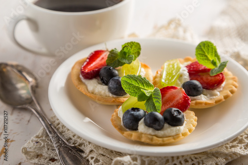 Small berry cakes on white background
