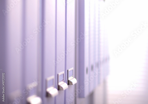 File folders  standing on  shelves in the background