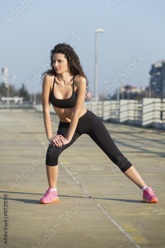 Young woman doing stretches outdoors