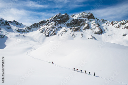 Group of climbers roped to the summit photo