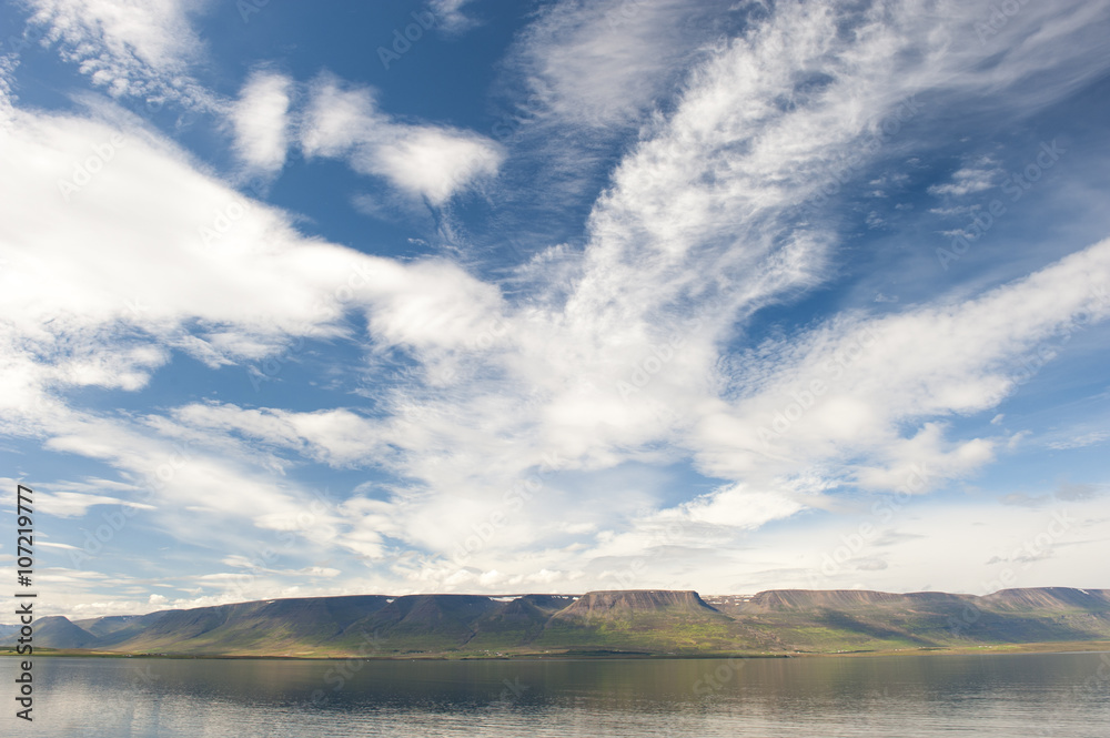 Summer fjord landscape with mountains and clouds, polar filter, Akureyri, Iceland