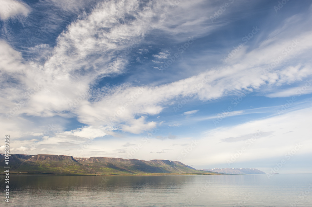 Summer fjord landscape with mountains and clouds, polar filter, Akureyri, Iceland