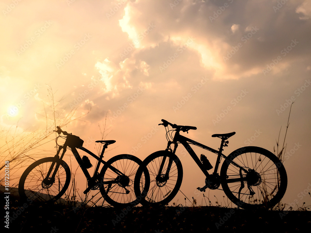 Obraz premium Silhouette of two bicycle at sunset