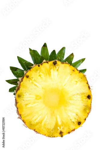 round slice of ripe tasty pineapple with leaf isolated on white