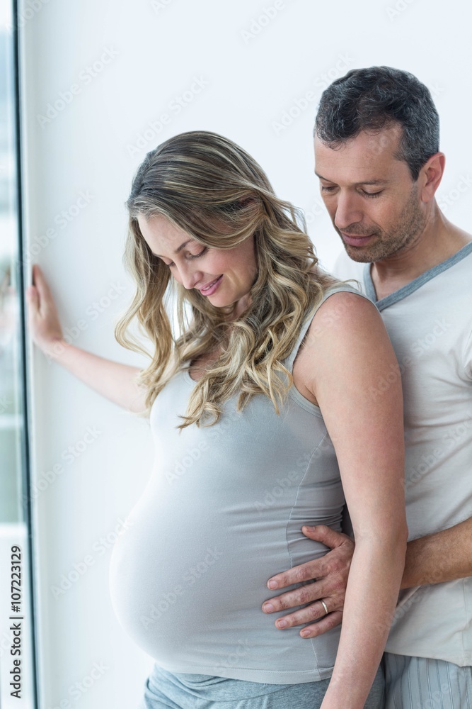 Man holding pregnant womans stomach Man holding pregnant womans stomach