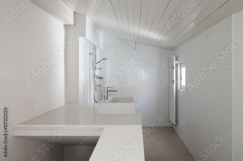 Interior  white bathroom with a small window