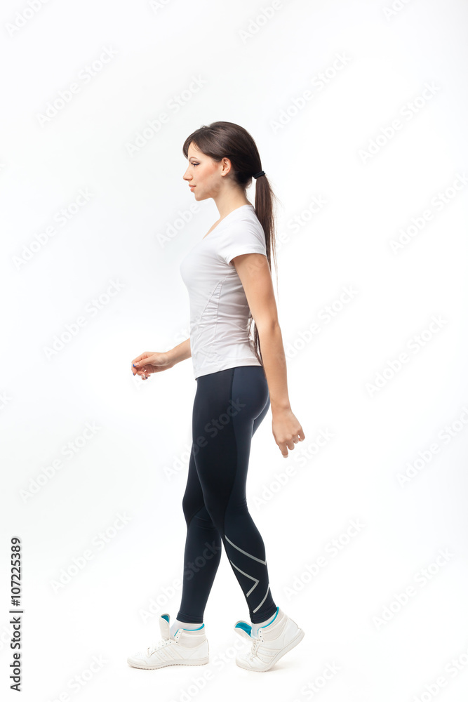 Full length of a young woman walking over white background Full length of a young woman walking over white background