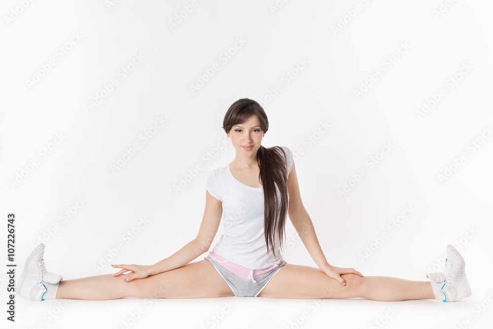 Young attractive female fitness woman performing a twine Young attractive female fitness woman performing a twine