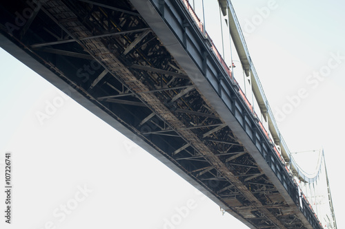 Fototapeta Naklejka Na Ścianę i Meble -  foot metal bridge over the river in the city