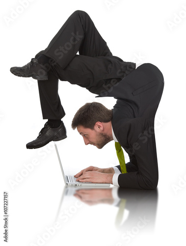 businessman work contortion with laptop isolated on white photo